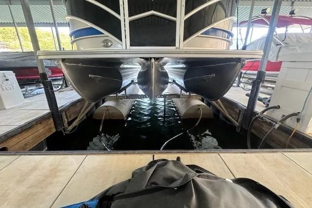 Slide: The Image of 2022 Berkshire 250CL STS pontoon boat docked in a marina. - 36