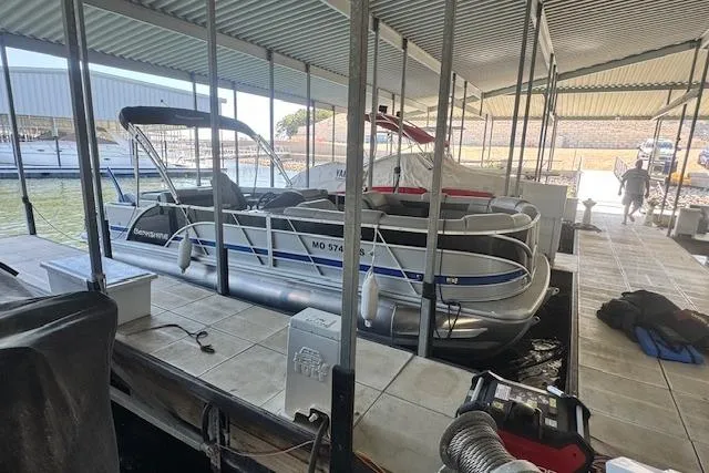 Slide: The Image of 2022 Berkshire 250CL STS pontoon boat docked in a covered marina. - 4