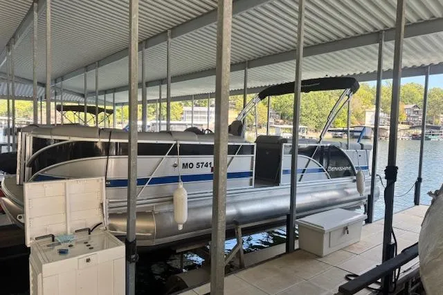Slide: The Image of 2022 Berkshire 250CL STS pontoon boat docked under covered marina. - 7