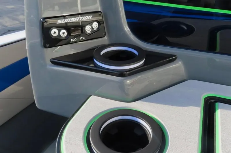 Slide: The Image of 2025 Sunsation 32 CCX boat dashboard with cup holders and control panel. - 10