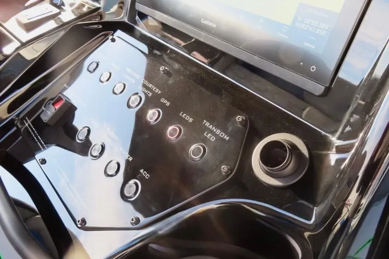 Slide: The Image of Control panel of 2025 Sunsation 32 CCX boat with switches and Garmin display. - 13
