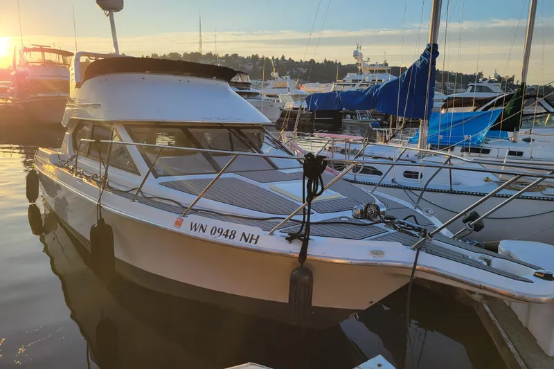 The Image of 1998 Bayliner 2858 Ciera Command Bridge docked at sunset in a marina. - 0