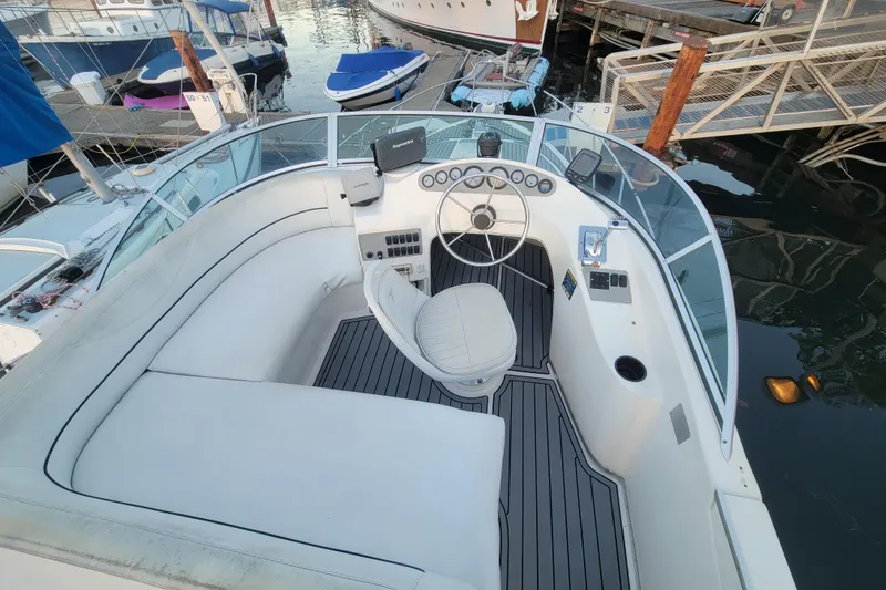 Slide: The Image of 1998 Bayliner 2858 Ciera Command Bridge cockpit with steering wheel and seating at marina. - 13