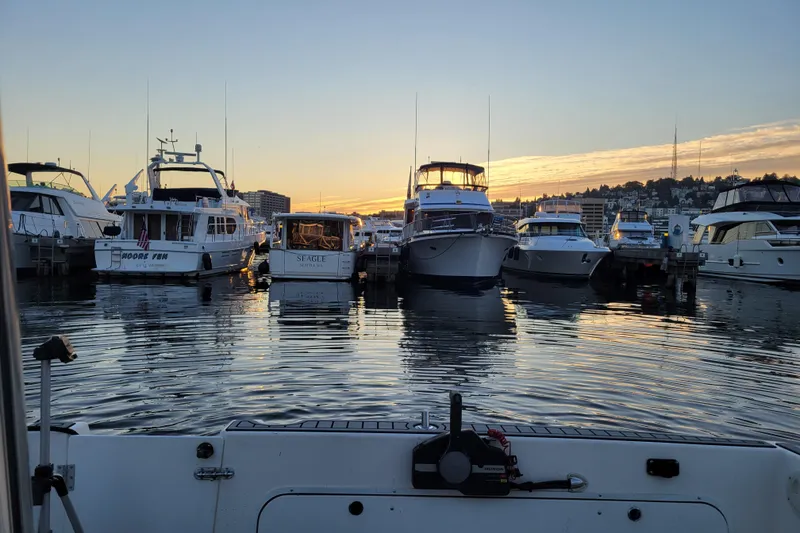 Slide: The Image of Boats docked at sunset, featuring a 1998 Bayliner 2858 Ciera Command Bridge. - 16
