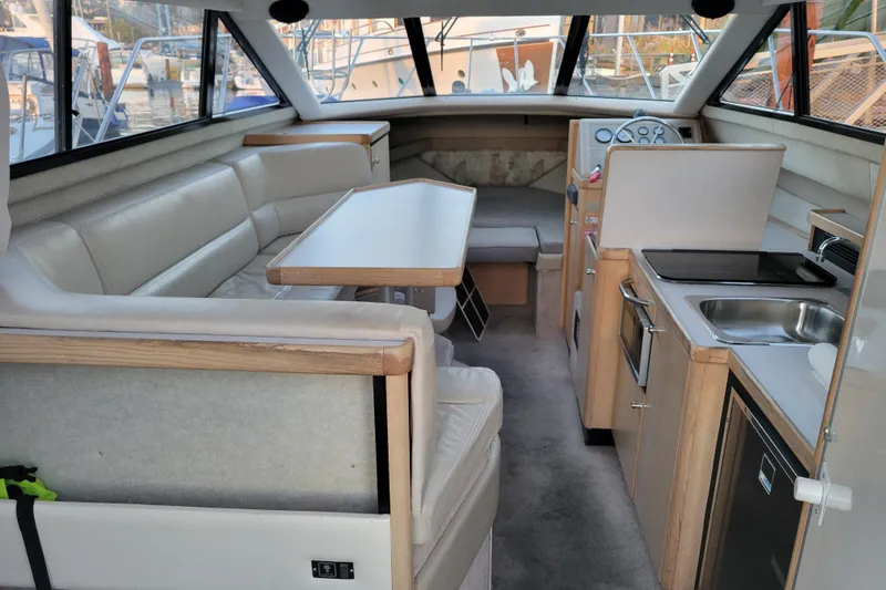 Slide: The Image of Interior of 1998 Bayliner 2858 Ciera Command Bridge with seating, table, and kitchenette. - 17