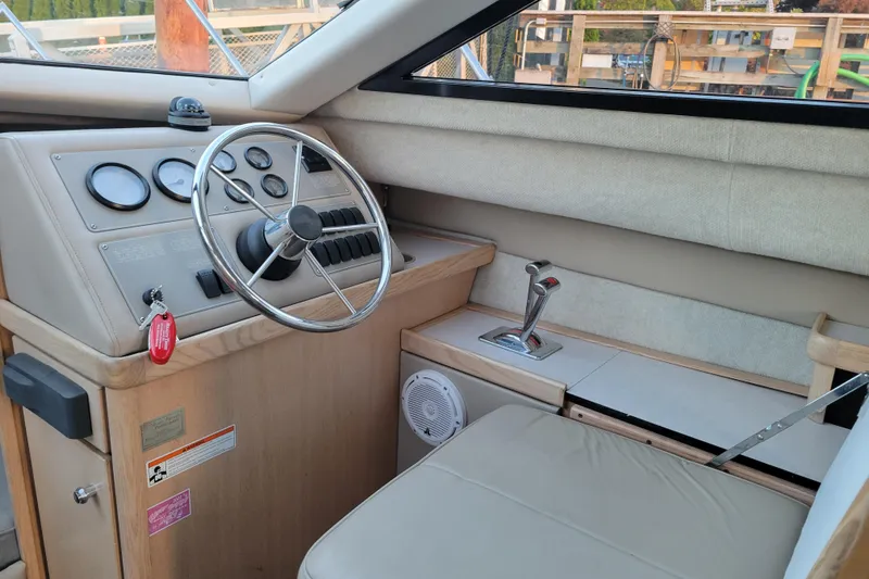 Slide: The Image of 1998 Bayliner 2858 Ciera Command Bridge helm with steering wheel and control panel. - 19