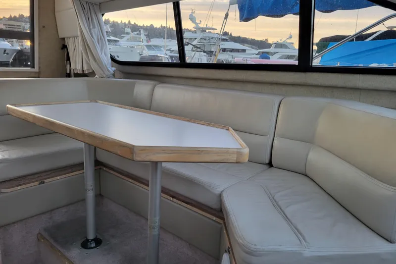 Slide: The Image of Interior of 1998 Bayliner 2858 Ciera Command Bridge with cushioned seating and table. - 26