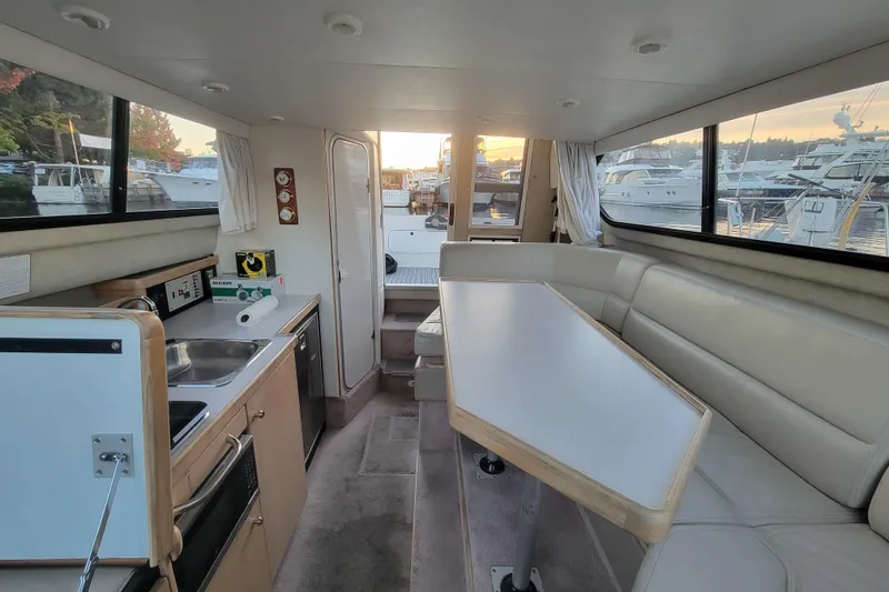 Slide: The Image of Interior of 1998 Bayliner 2858 Ciera Command Bridge with kitchen and seating area. - 27