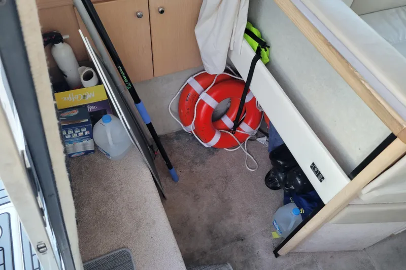 Slide: The Image of Interior of 1998 Bayliner 2858 Ciera Command Bridge with safety equipment and supplies. - 29