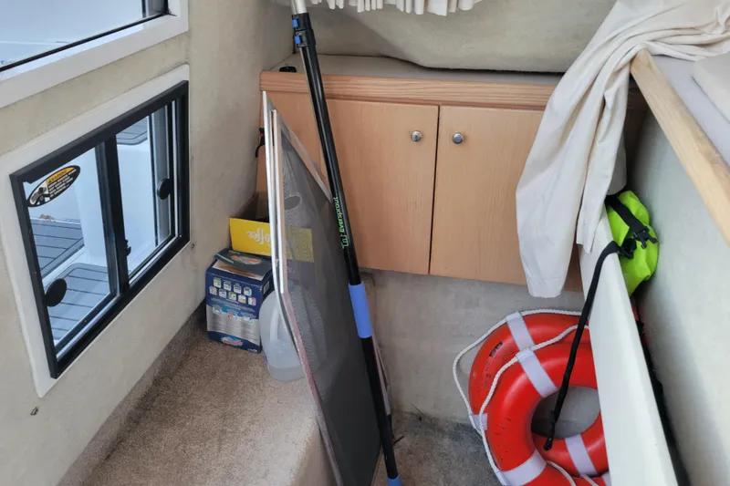 Slide: The Image of Interior of 1998 Bayliner 2858 Ciera with life preserver and cleaning supplies. - 30