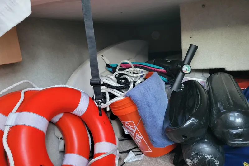 Slide: The Image of Storage area on a 1998 Bayliner 2858 Ciera with life rings, ropes, and fenders. - 31