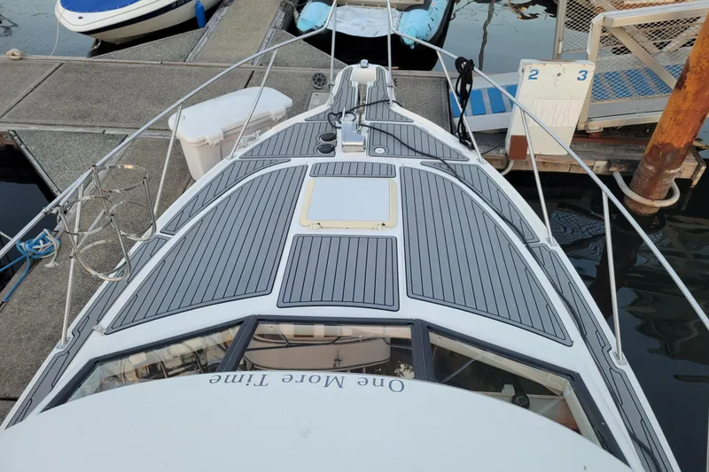 Slide: The Image of 1998 Bayliner 2858 Ciera Command Bridge docked, showcasing sleek deck design and marina setting. - 40
