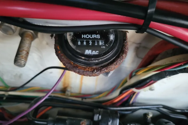 Slide: The Image of Hour meter with rust, surrounded by colorful wires in a 1998 Bayliner 2858 Ciera Command Bridge. - 45