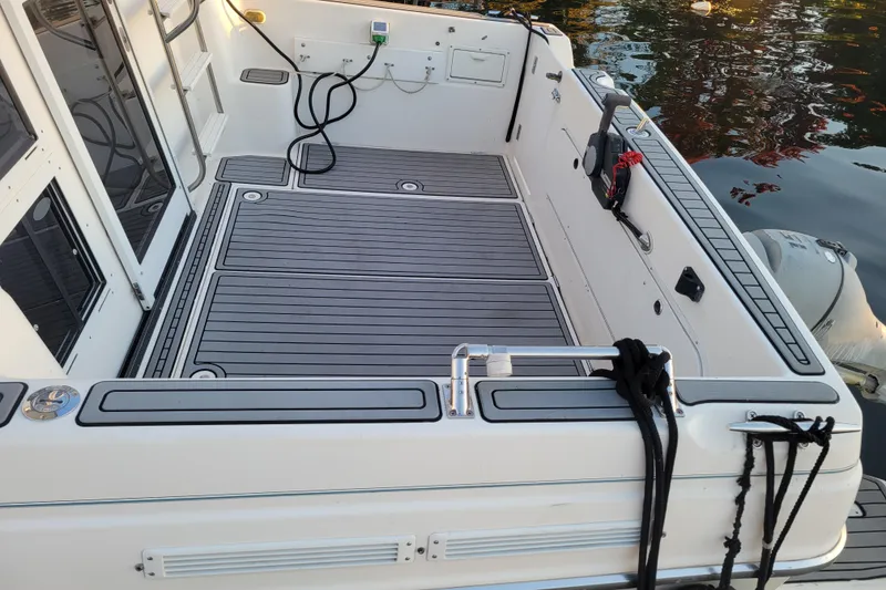 Slide: The Image of 1998 Bayliner 2858 Ciera Command Bridge boat deck with clean, modern design. - 6