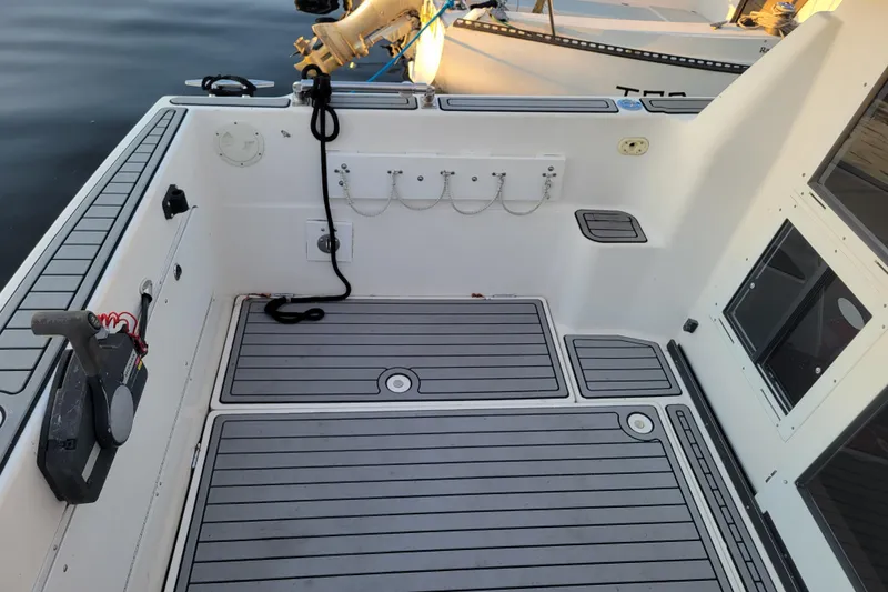 Slide: The Image of 1998 Bayliner 2858 Ciera Command Bridge boat deck with gray flooring and docked at marina. - 9