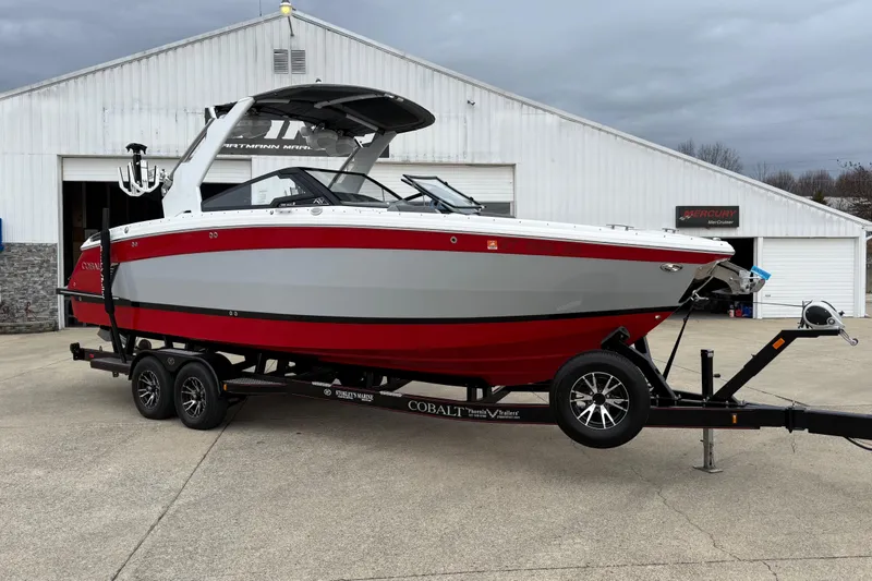 The Image of 2021 Cobalt R8 Surf boat on trailer in front of warehouse. - 0