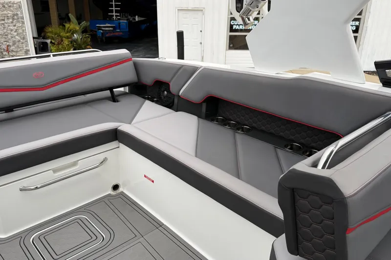 Slide: The Image of 2021 Cobalt R8 Surf boat interior with gray seating and red accents. - 15
