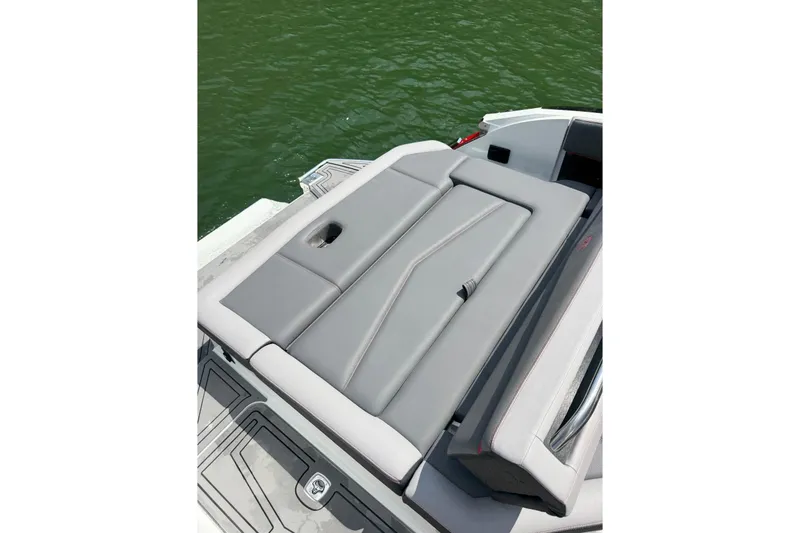 Slide: The Image of 2021 Cobalt R8 Surf boat on a serene lake with lush forest backdrop. - 6