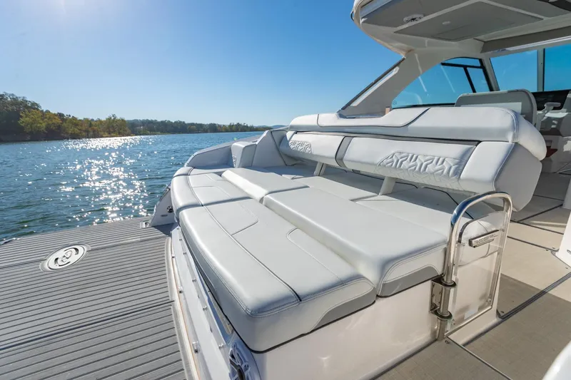 Slide: The Image of 2023 Regal LS36 luxury boat with spacious seating on a sunny lake. - 10