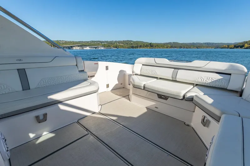 Slide: The Image of Luxurious 2023 Regal LS36 boat interior with spacious seating and scenic lake view. - 12