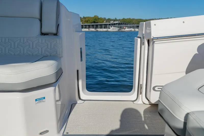 Slide: The Image of 2023 Regal LS36 boat interior with open door, overlooking serene blue water. - 14