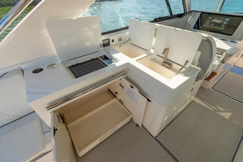 Slide: The Image of 2023 Regal LS36 yacht interior with kitchenette, featuring sink and storage compartments. - 18