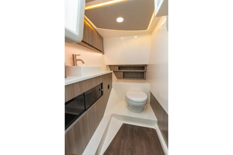 Slide: The Image of 2023 Regal LS36 boat interior bathroom with modern fixtures and wood accents. - 22