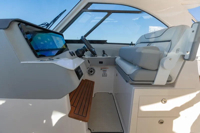 Slide: The Image of 2023 Regal LS36 boat interior with modern dashboard and comfortable seating. - 23