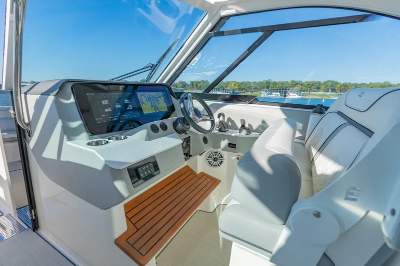 Slide: The Image of 2023 Regal LS36 boat cockpit with modern dashboard and comfortable seating. - 24