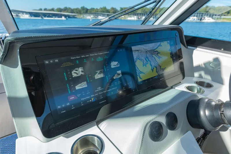 Slide: The Image of 2023 Regal LS36 boat dashboard with advanced navigation display and controls. - 26