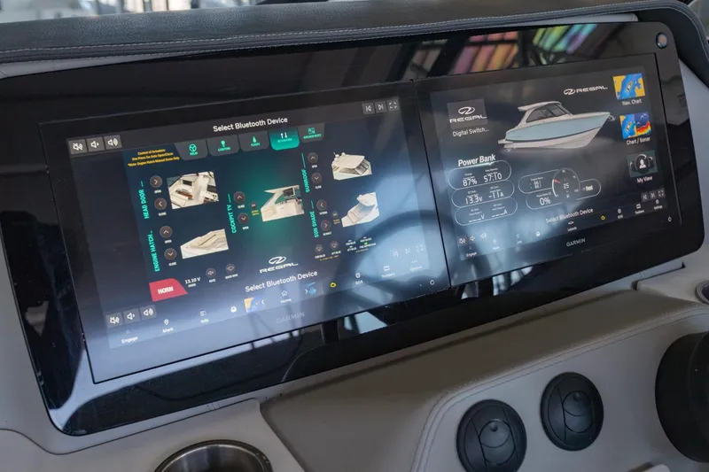 Slide: The Image of 2023 Regal LS36 boat dashboard with dual touchscreen displays showing navigation and control systems. - 27
