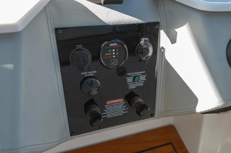Slide: The Image of Control panel of 2023 Regal LS36 boat featuring high water alarm and fire extinguisher indicators. - 29