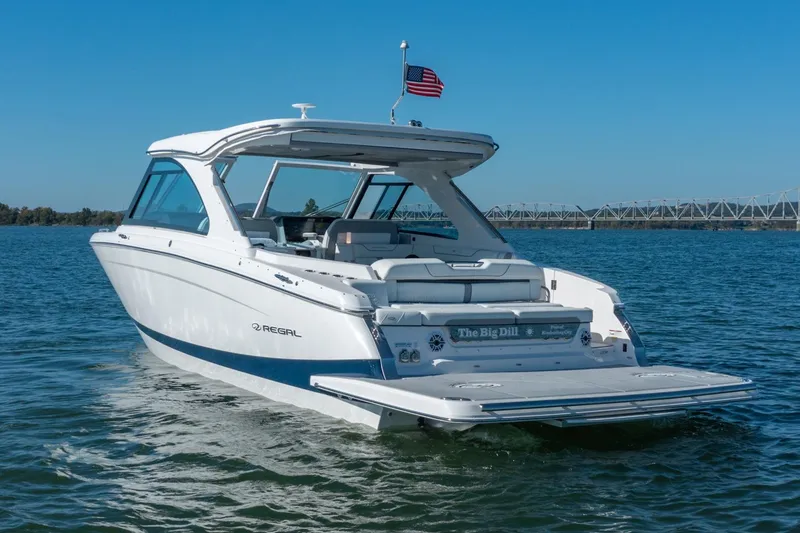 Slide: The Image of 2023 Regal LS36 boat cruising on a sunny day, American flag flying. - 3