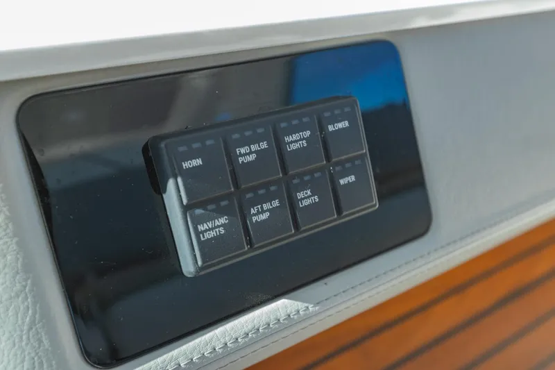 Slide: The Image of Control panel of 2023 Regal LS36 boat with labeled switches. - 30