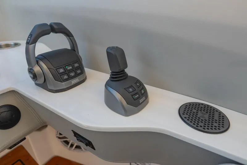 Slide: The Image of 2023 Regal LS36 boat controls and speaker on white console. - 31