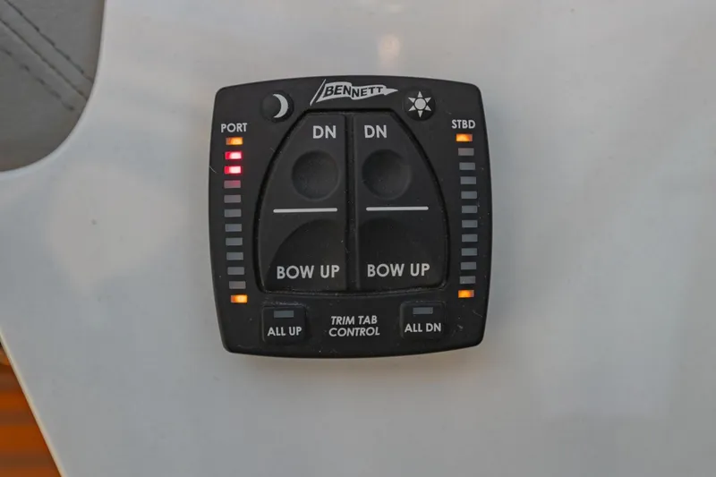 Slide: The Image of Control panel of a 2023 Regal LS36 boat with trim tab controls. - 35