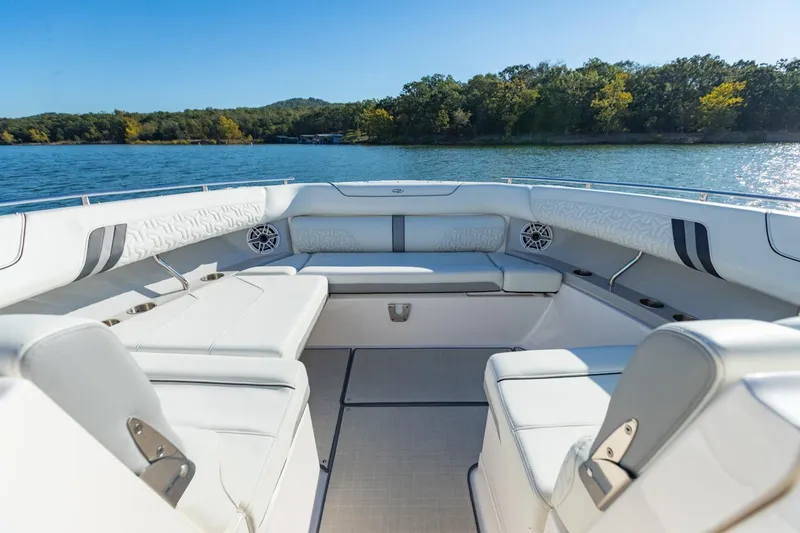 Slide: The Image of Luxurious 2023 Regal LS36 boat interior with white seating, on a serene lake. - 36