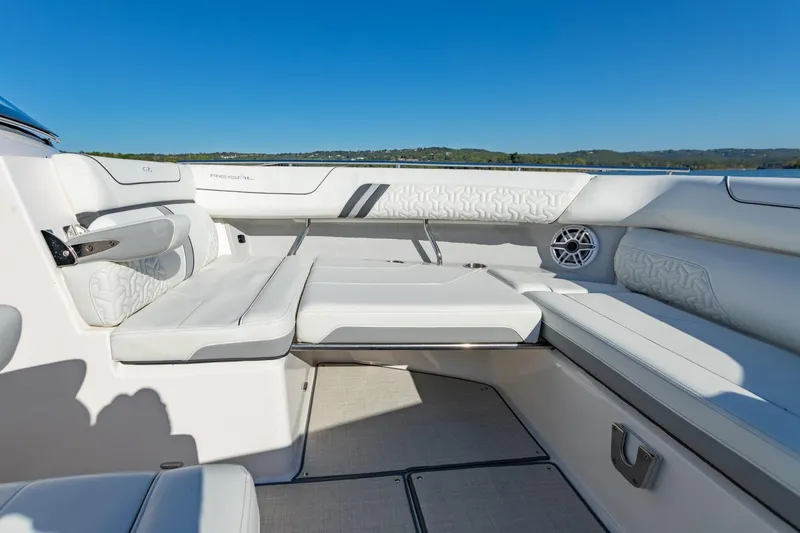 Slide: The Image of 2023 Regal LS36 boat interior with luxurious white seating and scenic lake view. - 37
