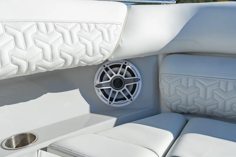 Slide: The Image of Luxurious white seating with speaker detail on 2023 Regal LS36 boat. - 40