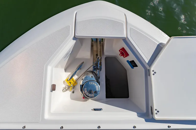 Slide: The Image of 2023 Regal LS36 boat anchor compartment with winch and safety equipment. - 41