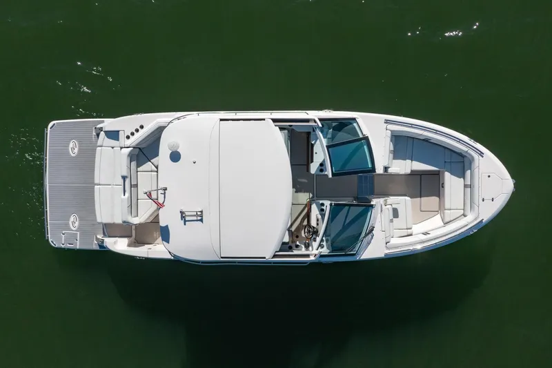 Slide: The Image of Top view of 2023 Regal LS36 boat on calm green water. - 6