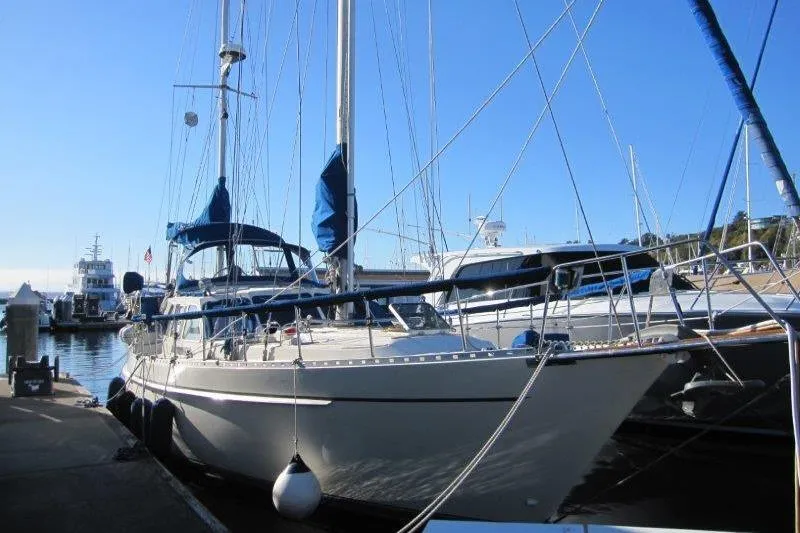 The Image of 1983 Nauticat 43 sailboat docked at a marina under clear blue skies. - 0