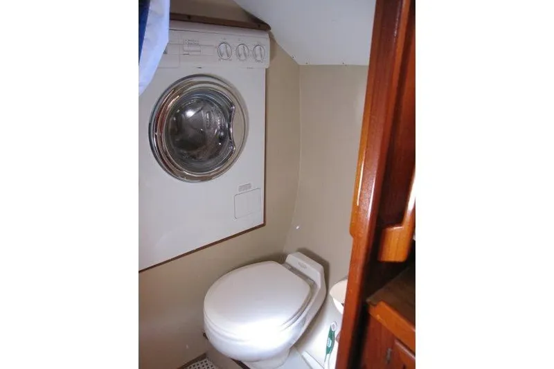 Slide: The Image of Interior helm of 1983 Nauticat 43 sailboat with wooden steering wheel and navigation equipment. - 2