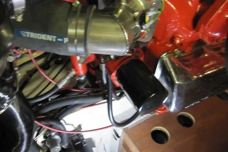 Slide: The Image of Engine components of a 1983 Nauticat 43, featuring Trident-P hose and red wiring. - 21