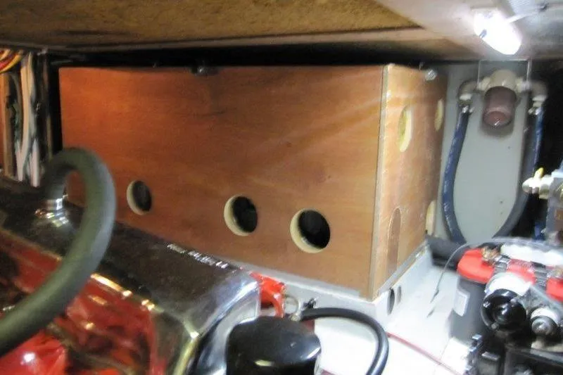 Slide: The Image of Engine compartment of 1983 Nauticat 43 sailboat, featuring wooden paneling and mechanical components. - 22