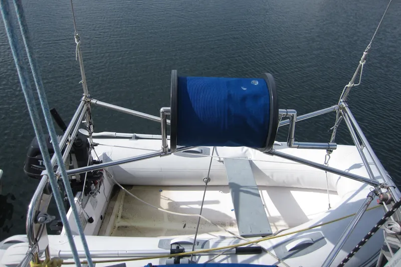 Slide: The Image of 1983 Nauticat 43 sailboat deck with winch and ropes, moored on calm water. - 28