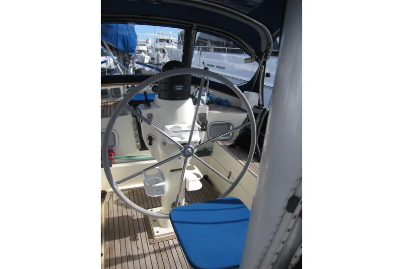 Slide: The Image of Cockpit of 1983 Nauticat 43 sailboat with steering wheel and blue seating. - 29