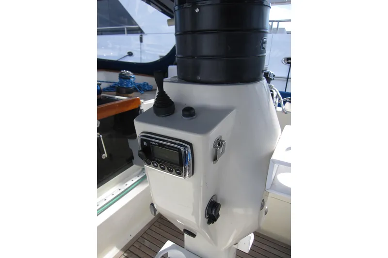 Slide: The Image of Cockpit controls of 1983 Nauticat 43 sailboat, featuring navigation equipment and steering mechanisms. - 30