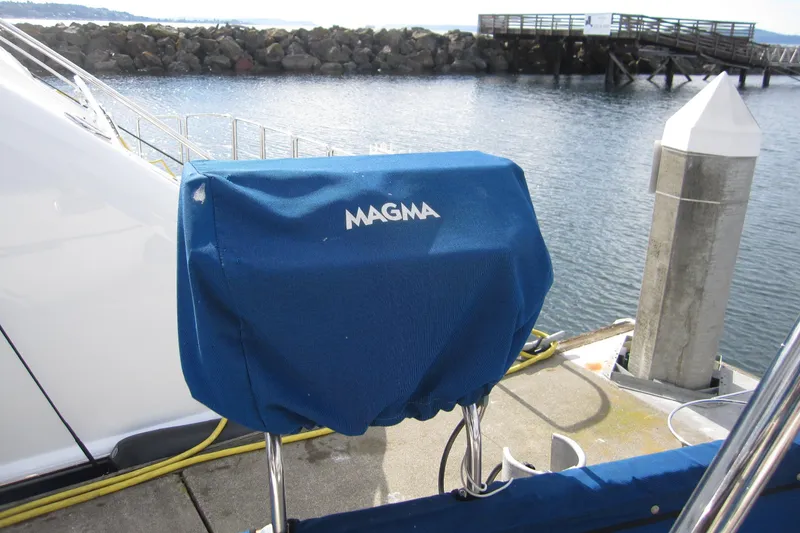 Slide: The Image of Blue Magma grill cover on 1983 Nauticat 43 yacht docked by the water. - 31