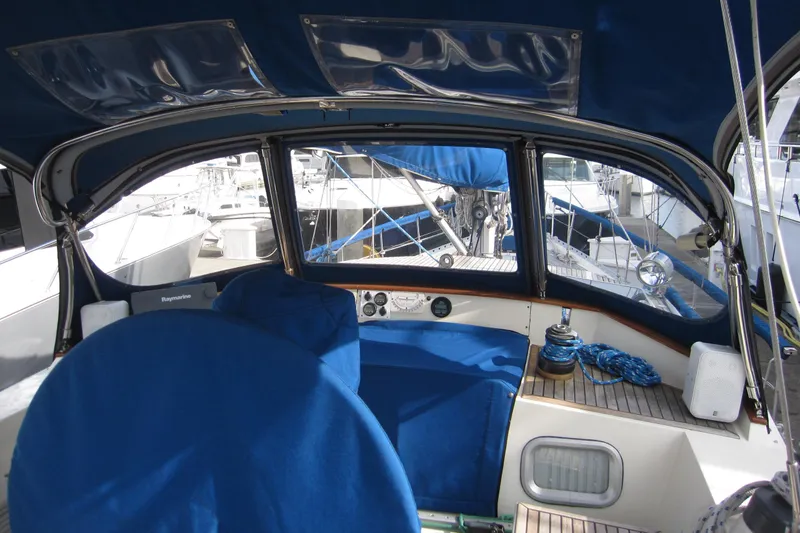 Slide: The Image of Cockpit of 1983 Nauticat 43 sailboat with blue covers and nautical equipment. - 32